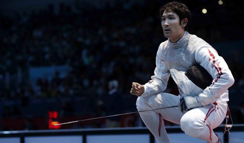 Ryo Miyake of Japan reacts during his match against Ma Jianfei of China in the men's foil team fencing competition at the 2012 Summer Olympics.