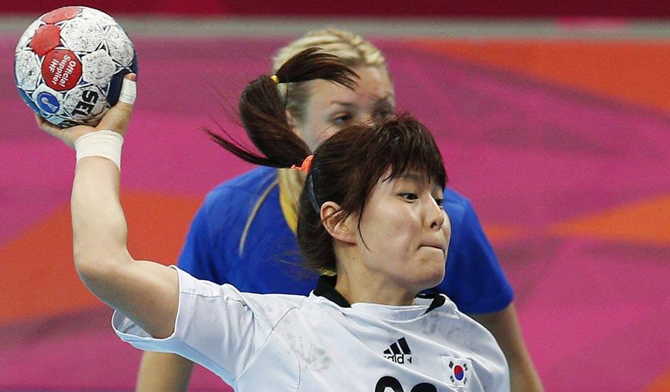 South Korea's Jung Ji-hae shoots in front of Sweden's Isabelle Gullden, during their women's handball preliminary match at the 2012 Summer Olympics.