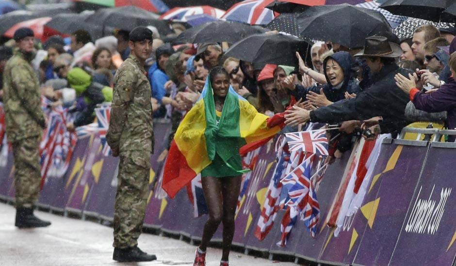 Ethiopia's gold medal winner Tiki Gelana celebrates with her country's flag after the women's marathon at the 2012 Summer Olympics.