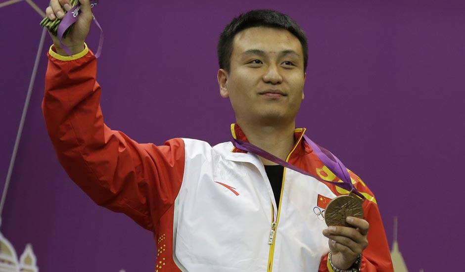 China's Wang Zhiwei reacts after receiving the bronze medal for the men's 50-meter pistol, at the 2012 Summer Olympics.