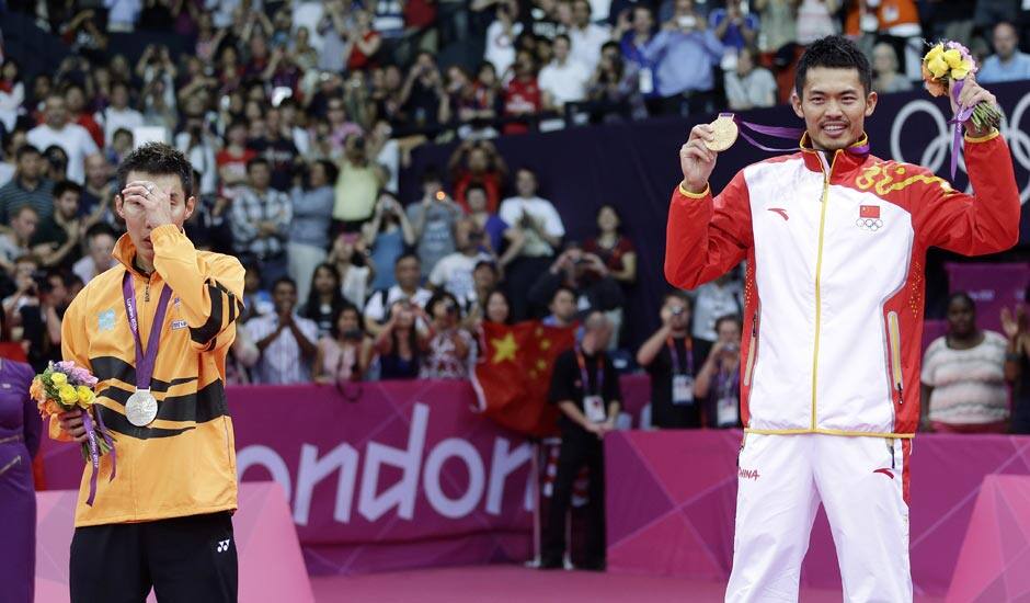 China's Lin Dan, right, shows his gold medal after winning the men's singles badminton gold medal match defeating Malaysia's Lee Chong Wei, left, at the 2012 Summer Olympics.