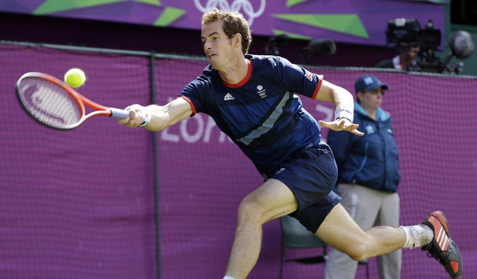 Andy Murray of Great Britain returns to Roger Federer of Switzerland during the gold medal men's singles match at the All England Lawn Tennis Club in Wimbledon, London at the 2012 Summer Olympics.