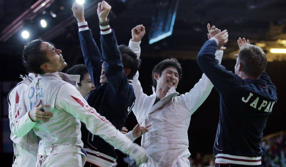 Team Japan celebrate beating Germany to advance to the finals during the men's foil team fencing competition at the 2012 Summer Olympics.