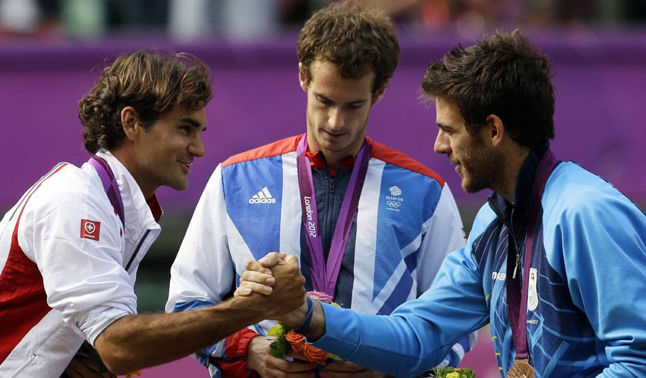 Silver medalist Switzerland's Roger Federer, right, shakes hands with bronze medalist Juan Martin del Potro of Argentina, right, as Gold medalist Andy Murray of Great Britain, center, stands during the medal ceremony of the men's singles event at the All England Lawn Tennis Club at Wimbledon in London Olympics