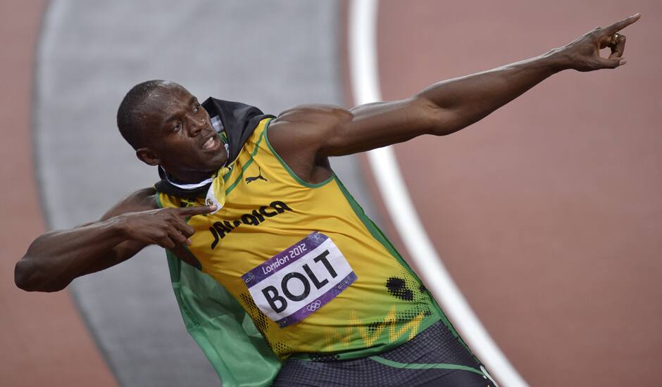 Jamaica's Usain Bolt wears his national flag following his win in the men's 100-meter final during the athletics in the Olympic Stadium at the 2012 Summer Olympics, London.