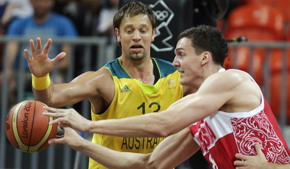 Russia's Sasha Kaun, right, passes as he is pressured by Australia's David Andersen during a men's basketball game at the 2012 Summer Olympics.