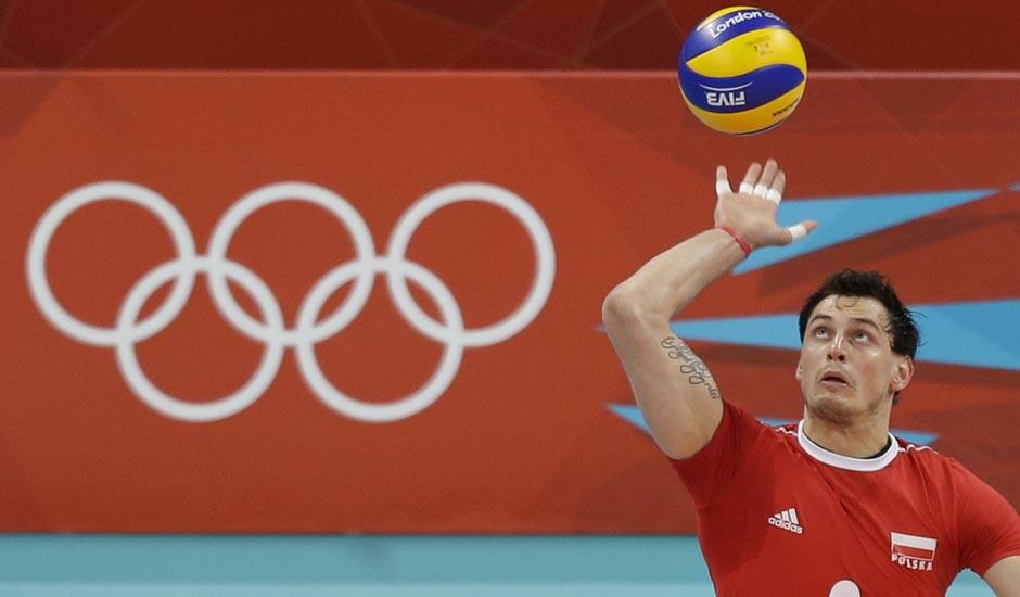 Poland's Zbigniew Bartman (9) serves the ball to Australia during a men's volleyball preliminary match at the 2012 Summer Olympics.