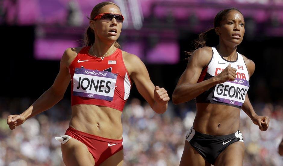 United States' Lolo Jones, left, and Canada's Phylicia George compete in a women's 100-meter hurdles heat during the athletics in the Olympic Stadium at the 2012 Summer Olympics.