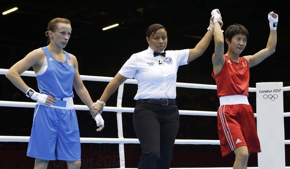 China's Ren Cancan, right, celebrates after defeating Russia's Elena Savelyeva, left, in a women's flyweight 51-kg quarterfinal boxing match at the 2012 Summer Olympics.