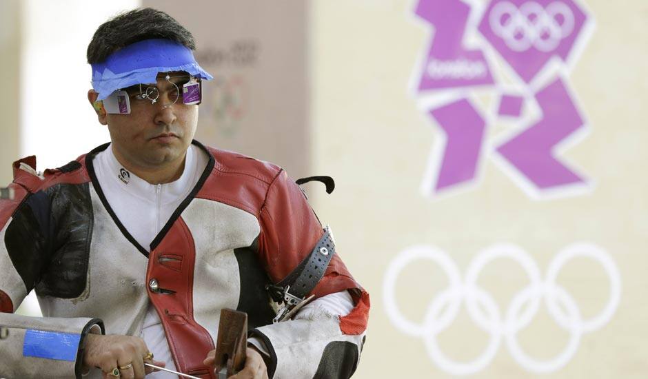 Gagan Narang adjusts his rifle as he prepares to switch from prone to standing position, during qualifiers for the men's 50-meter rifle 3 positions, at the 2012 Summer Olympics.