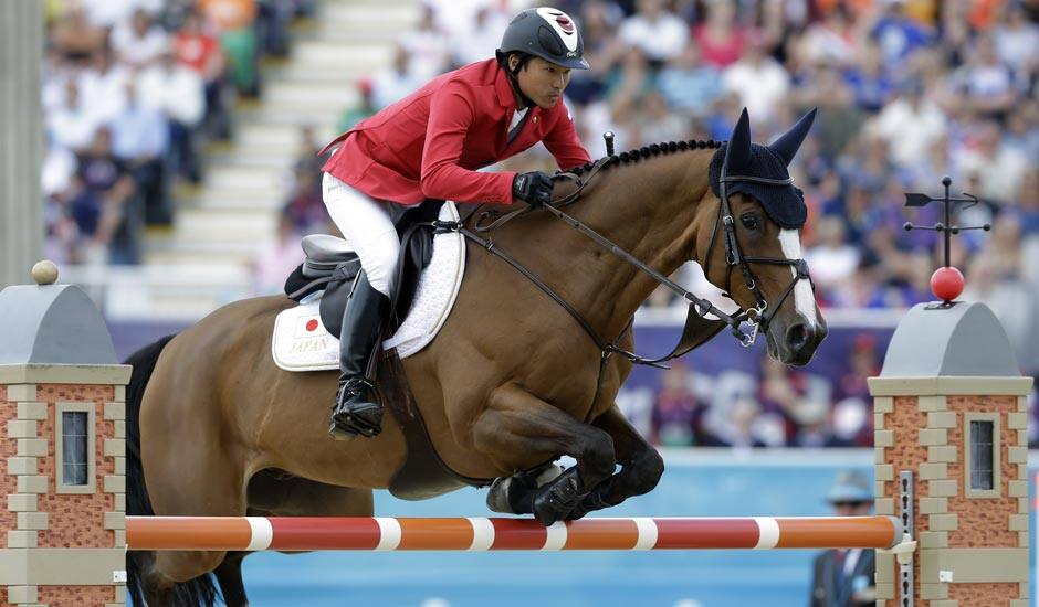 Japan's Taizo Sugitani rides Avenzio during the equestrian show jumping competition at the 2012 Summer Olympics.