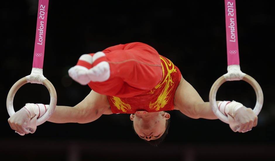 Chinese gymnast Chen Yibing performs on the rings during the artistic gymnastics men's apparatus finals at the 2012 Summer Olympics.