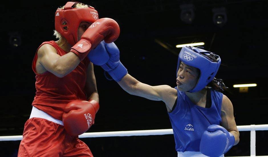 Chungneijang Mery Kom Hmangte, right, fights Tunisia's Maroua Rahali during a women's flyweight 51-kg quarterfinal boxing match at the 2012 Summer Olympics.