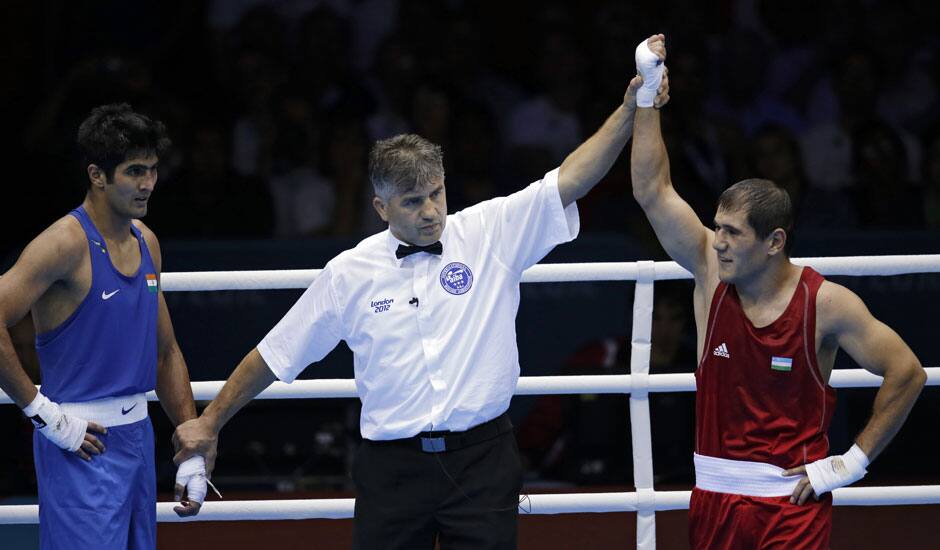 Uzbekistan's Abbos Atoev, right, defeats India's Vijender Singh in a middleweight 75-kg quarterfinal boxing match at the 2012 Summer Olympics.