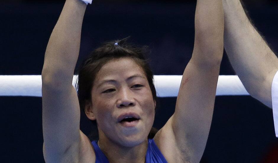 India's Chungneijang Mery Kom Hmangte celebrates after defeating Tunisia's Maroua Rahali in a women's flyweight 51-kg quarterfinal boxing match at the 2012 Summer Olympics.