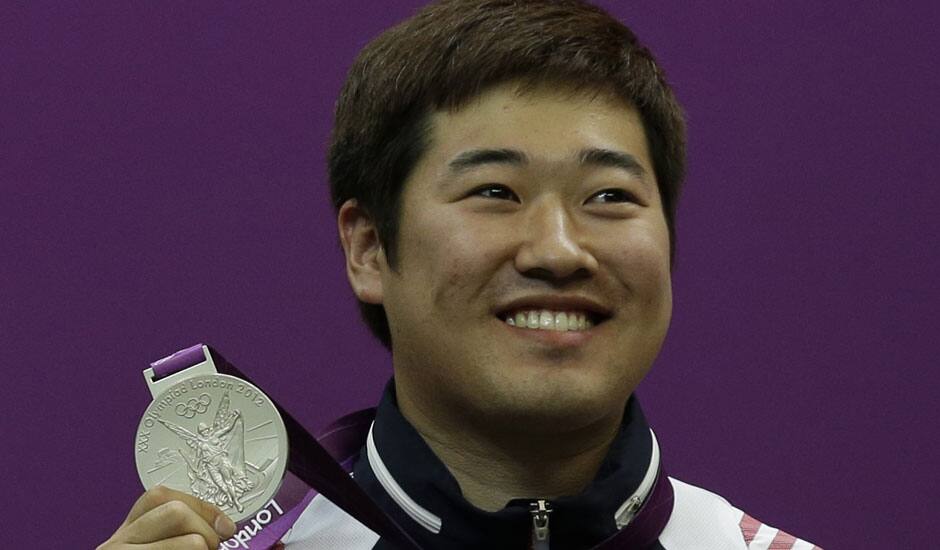 South Korea's Kim Jonghyun holds up his silver medal, during the victory ceremony for the men's 50-meter rifle 3 positions event, at the 2012 Summer Olympics.