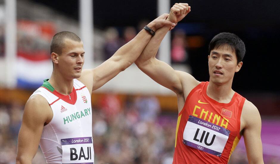 China's Liu Xiang, and Hungary's Balazs Baji, react after Liu's fall in a men's 110-meter hurdles heat during the athletics in the Olympic Stadium at the 2012 Summer Olympics, London.