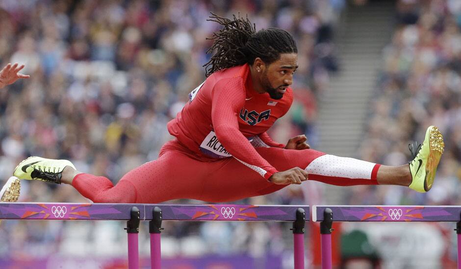 United States' Jason Richardson clears a hurdle in a men's 110-meter hurdles heat during the athletics in the Olympic Stadium at the 2012 Summer Olympics, London.