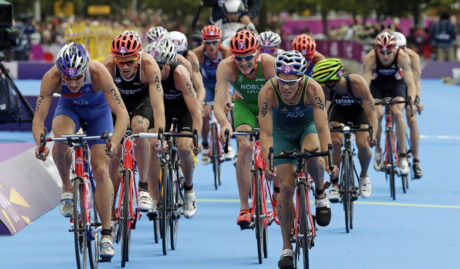 Russia's Alexander Bryukhankov, left, and Australia's Courtney Atkinson compete in the men's triathlon at the 2012 Summer Olympics in London. 