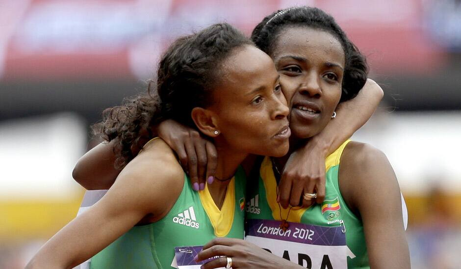 Ethiopia's Meseret Defar, embraces compatriot Ethiopia's Tirunesh Dibaba after competing in a women's 5000-meter heat during the athletics in the Olympic Stadium at the 2012 Summer Olympics, London.