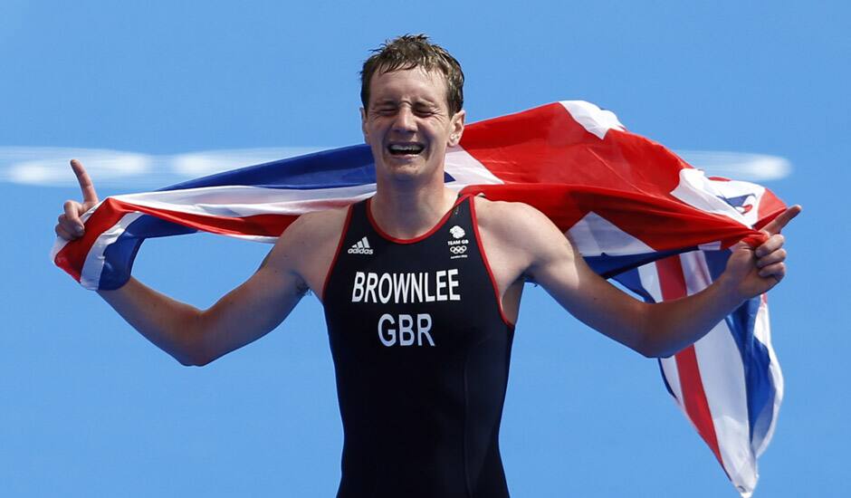 Great Britain's Alistair Brownlee reacts as he crosses the finish line to win the gold medal in the men's triathlon at the 2012 Summer Olympics in London.