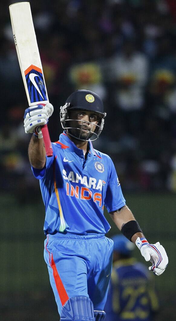 Virat Kohli celebrates after scoring a half-century during a Twenty20 cricket match between India and Sri Lanka in Pallekele.