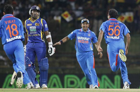 Irfan Pathan celebrates the dismissal of Sri Lanka's batsman Mahela Jayawardene, with Suresh Raina, during a Twenty20 cricket match between India and Sri Lanka in Pallekele.