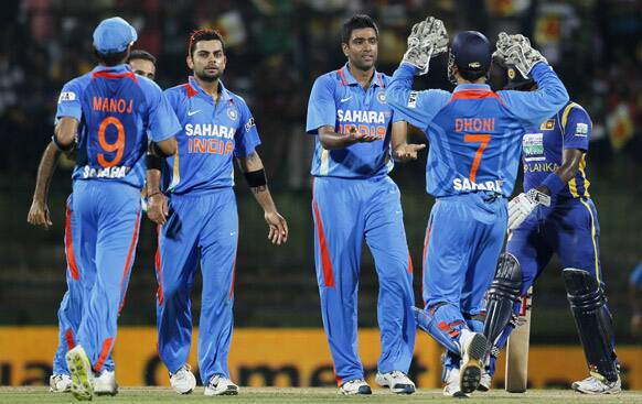 Ravichandran Ashwin celebrates the dismissal of Sri Lanka's batsman Lahiru Thirimanne during a Twenty20 cricket match between India and Sri Lanka in Pallekele.