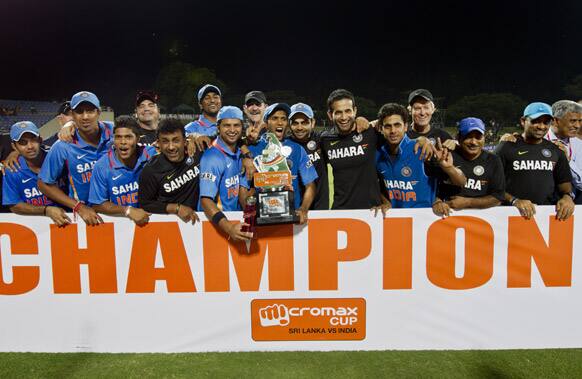 India's cricketers and officials pose for a photographers with the winners cup after India beat Sri Lanka in the one-off Twenty20 cricket match in Pallekele.