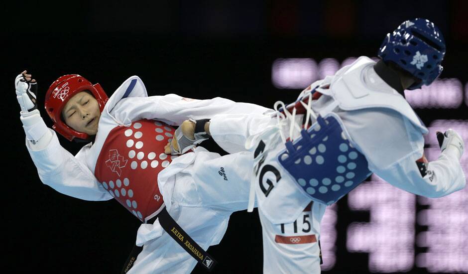 Papua New Guinea's Theresa Tona fights Japan's Erika Kasahara (in red) during their match in women's 49-kg taekwondo competition at the 2012 Summer Olympics.