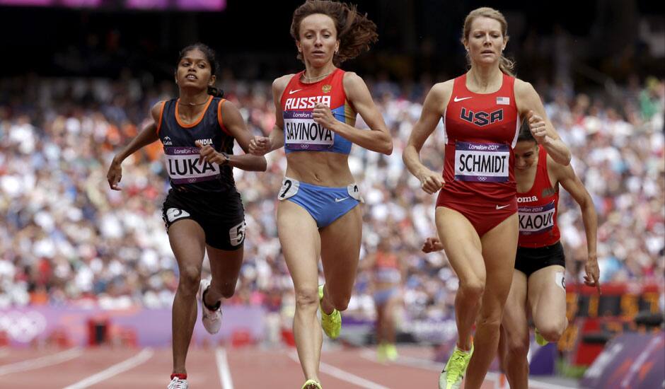 United States' Alice Schmidt leads Russia's Mariya Savinova and India's Tintu Luka across the finish line in a women's 800m heat during the athletics in the Olympic Stadium at the 2012 Summer Olympics in London