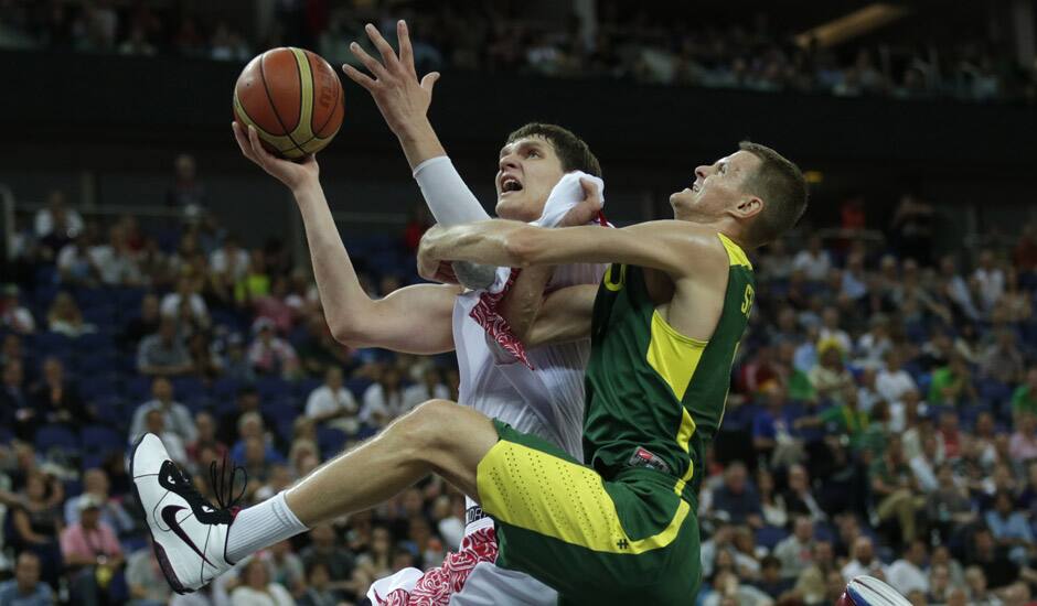 Russia's Timofey Mozgov, drives to the basket past Lithuania's Renaldas Seibutis during a men's quarterfinals basketball game at the 2012 Summer Olympics in London. 