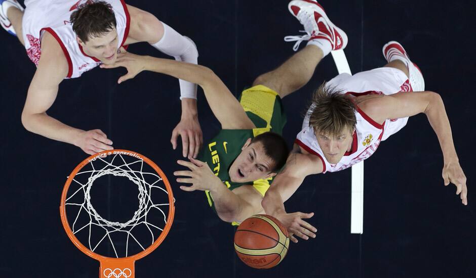 Russia's Andrei Kirilenko, and Timofey Mozgov, battle Lithuania's Paulius Jankunas, for a rebound during a men's quarterfinals basketball game at the 2012 Summer Olympics in London.