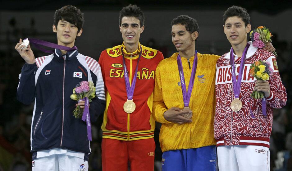 Gold medalist Spain's Joel Gonzalez Bonilla,  stands on the podium with silver medalist South Korea's Lee Dae-hoon, bronze medalist Colombia's Oscar Munoz Oviedo and bronze medalist Russia's Alexey Denisenko, during the medal ceremony for the men's 58-kg taekwondo competition.