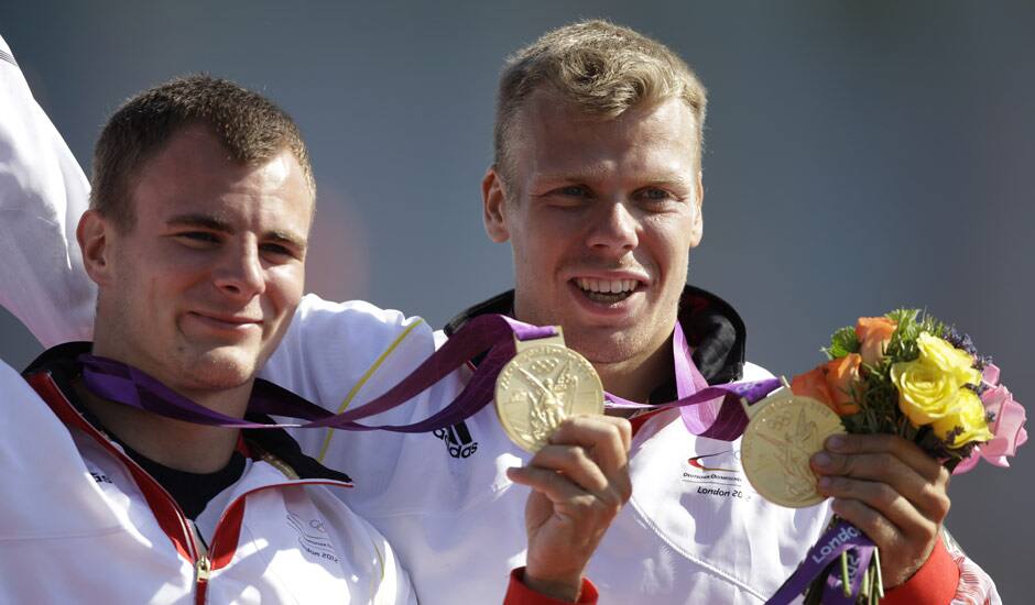 Germany's Peter Kretschmer, and Kurt Kuschela display the gold medal men's they won in the canoe double 1000m in Eton Dorney, near Windsor, England, at the 2012 Summer Olympics.