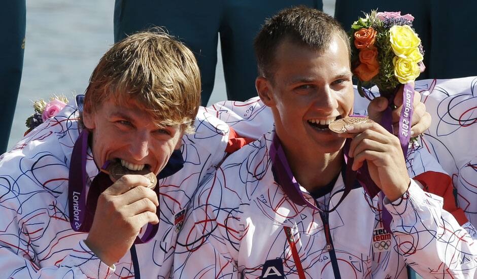 Czech Republic's Daniel Havel, and Likas Trefil, bite the bronze medals they won in the bronze medal men's kayak four 1000m in Eton Dorney, near Windsor, England, at the 2012 Summer Olympics.