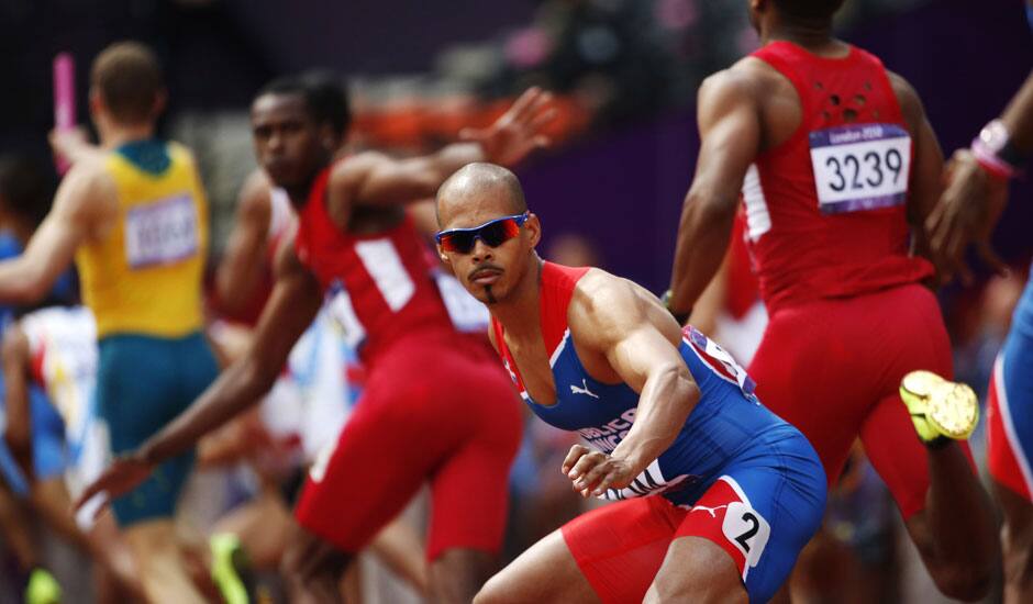 Dominican Republic's Felix Sanchez waits for the baton during a men's 4x400-meter relay heat during the athletics in the Olympic Stadium at the 2012 Summer Olympics, London.