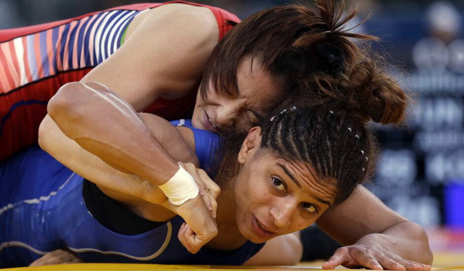 Um Jieun of South Korea competes against Marwa Amri of Tunisia (in blue) during a 55-kg women's freestyle wrestling competition at the 2012 Summer Olympics, in London.