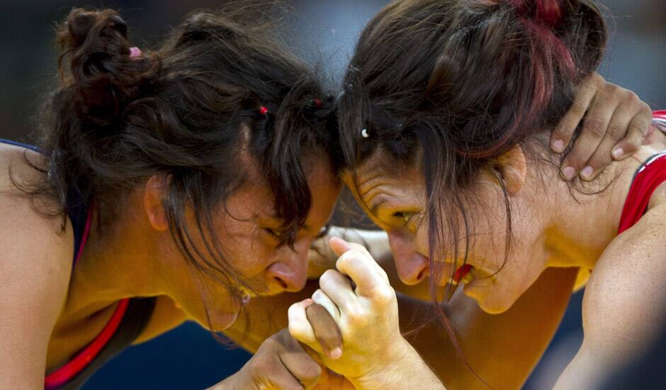 Canada's Tonya Verbeek, goes head to head with India's Geeta Geeta during a 55-kg women's freestyle wrestling competition at the 2012 Summer Olympics, in London.