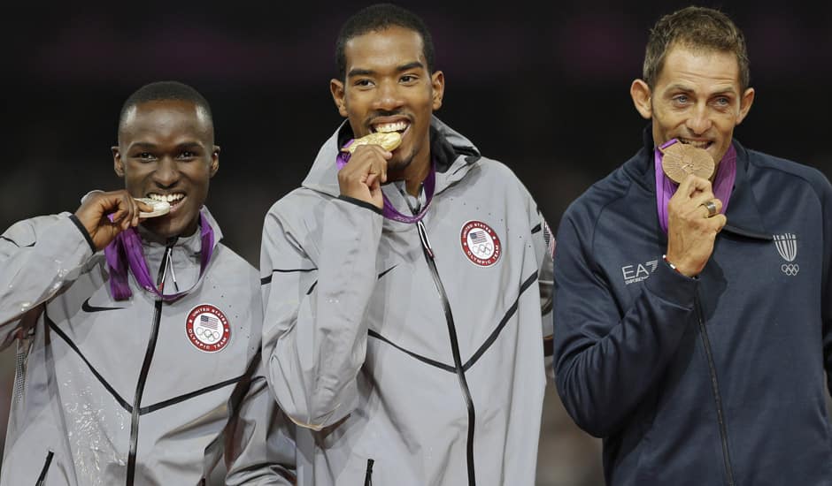 United States' gold medal winner Christian Taylor, is flanked by silver medal medal winner Will Claye, left, and bronze medal winner Fabrizio Donato from Italy during the ceremony for the men's triple jump during the athletics in the Olympic Stadium at the 2012 Summer Olympics.