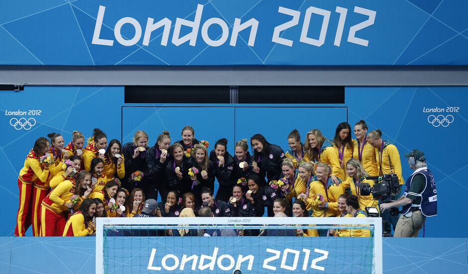 Members of the Spanish, left, United States and Australian women's water polo team pose on the podium with their medals after following the women's water polo gold medal match at the 2012 Summer Olympics.