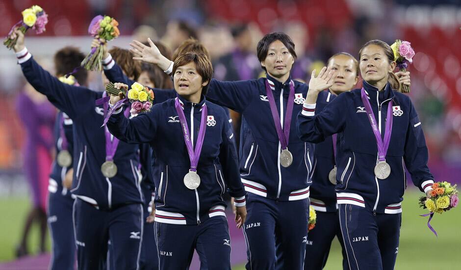 Japan soccer players celebrate winning the silver medal after being defeated in the women's soccer final against the United States at the 2012 Summer Olympics.