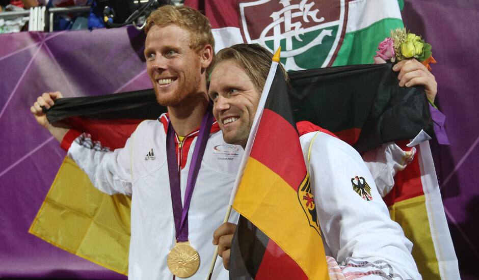 Germany's Jonas Reckermann, left, and Julius Brink, right, pose for a photograph after winning the men's gold medal beach volleyball match at the 2012 Summer Olympics.