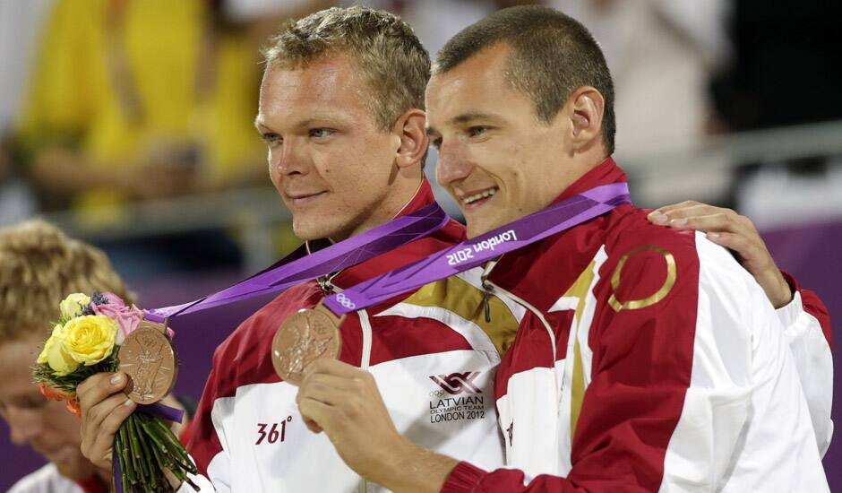 Latvia's Janis Smedins, left, and Martins Plavins celebrate with their bronze medals during medal ceremonies at the Beach Volleyball Venue at the 2012 Summer Olympics.