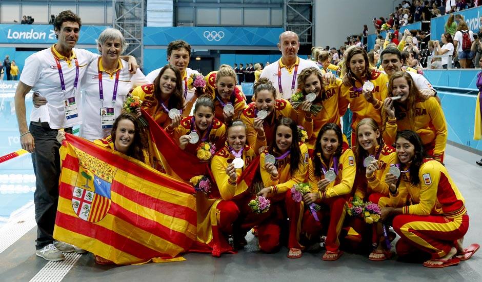 Members of the Spainsh water polo team pose with their silver medals after they were defeated by the United States in their women's water polo gold medal match at the 2012 Summer Olympics.