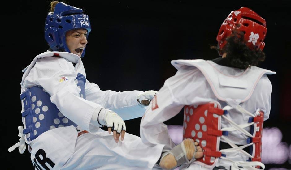 Turkey's Nur Tatar fights Grenada's Andrea St. Bernard (in red) during their match in women's 67-kg taekwondo competition at the 2012 Summer Olympics.