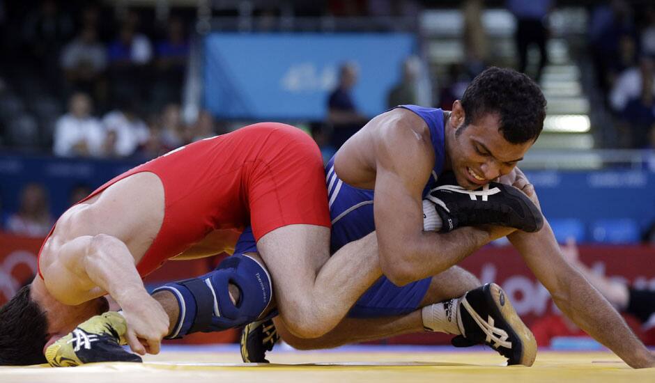 Georgia's Vladimer Khinchegashvili,  and Egypt's Ibrahim Farag Abdelhakim Mohamed compete during a 55-kg men's freestyle wrestling competition at the 2012 Summer Olympics in London. 