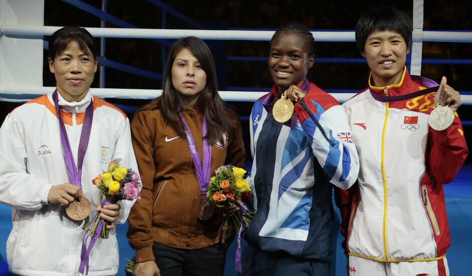 Bronze medalist, Mery Kom Hmangte, bronze medalist Marlen Esparza of the United States, gold medalist Nicola Adams of Great Britain, and silver medalist Ren Cancan of China participate in the medals ceremony for women's final flyweight 51-kg gold medal boxing match at the 2012 Summer Olympics.