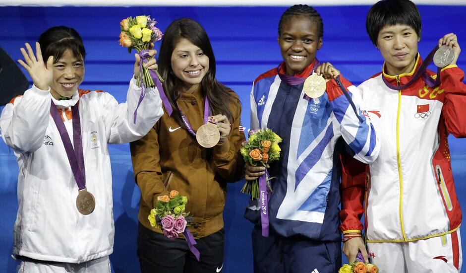 Bronze medalist, Mery Kom Hmangte, bronze medalist Marlen Esparza of the United States, gold medalist Nicola Adams of Great Britain, and silver medalist Ren Cancan of China participate in the medals ceremony for women's final flyweight 51-kg gold medal boxing match at the 2012 Summer Olympics.