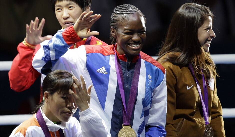 Silver medalist Ren Cancan, bronze medalist, Mery Kom Hmangte, bottom, gold medalist Nicola Adams of Great Britain, and bronze medalist Marlen Esparza of the United States, participate in the medals ceremony for women's final flyweight 51-kg gold medal boxing match at the 2012 Summer Olympics.